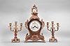 A.D. Mougin, Paris for Camerden & Forster of New York, mantel clock, 8 day, time and strike, spring driven pendule de Paris movement in a Louis XV style case with tortoise shell veneer and rococo style brass ornament, white enamel dial with retailer's name, steel hands, two matching candelabra holding 3 candles each.
