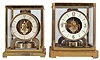 Clocks- 2 (Two) Atmos: (1) Jaeger-LeCoultre, Switzerland, "Atmos" clock, 15 jewel, caliber 526-5 movement, torsion pendulum, round metal dial with applied gilt arrow markers, gilt hands, all contained in a rectangular case with original cloth covered box, serial #83408, c1955; (2) Jaeger-LeCoultre, Switzerland, "Atmos" clock, 15 jewel movement, torsion pendulum, round metal dial with applied gilt numerals, arrow markers, and hands.