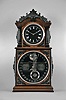 Ithaca Calendar Clock Co., Ithaca, NY, "3 1/2 Parlor" shelf clock with an E. N. Welch spring driven 8 day time and strike movement with a patented perpetual calendar mechanism in a walnut case with ebony trimmings and a customized wall shelf (modern) in the style of the clock case.