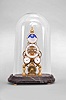 Clocks- 3 (Three): (1) France, portico clock, 8 day, time and strike, spring driven pendule to Paris movement with gridiron pendulum in a case featuring a riot of decorative elements including tortoise shell veneer, ebonized twist turned columns, and cast brass garlands, capitals and edge molding, with a white enamel dial and blued steel Breguet style hands, c1860; (2) Horolovar, Bronxville, New York, reproduction of 1855 Briggs rotary clock, 8 day, time only, spring driven movement with conical pendulum on a wood base under a glass dome, c1980; (3) Skeleton clock reproduction, 8 day, time and calendar functions with moon phase, spring driven fusee movement in a polished brass skeletonized frame on a black marble base, all under an oval glass dome, c1990.