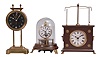Clocks- 3 (Three): (1) France, gravity clock, 30 hour, time only, weight driven movement with compound barbell pendulum in a brass case with glass dial, c1925; (2) Briggs rotary pendulum novelty clock reproduction, 30 hour, spring driven movement with conical pendulum on a wood stand under a glass dome, c1980; (3) Horolovar Clock Co., Bronxville, New York reproduction "Ignatz Flying Pendulum" novelty clock, 30 hour, time only, in a brown wood case, c1975.