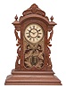 Ansonia Clock Co., New York, NY, "Broadway" shelf clock, 8 day, time and strike, spring driven movement in a walnut and burled walnut veneer case with carved elements.