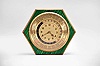 Gubelin, Switzerland, a hexagonal, faux malachite and gilt brass world time table clock, the case on compressed ball feet with upper and lower plates connected by pillars, and separated by a cylindrical mid section, fluted bezel with convex glass, the time display with outer ring engraved with important international cities, surrounding a 24 hour dial, and with central 12 hour dial, powered 8 day timepiece movement with lever escapement