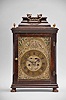 Austria, a late 18th century, repeating bracket clock with mock pendulum, ebonized hardwood case on compressed, silvered ball feet, plain rectangular door allowing a veiw of the decorative dial, molded top with brass finials and caddy top with brass handle, case sides with tombstone arch windows, and back also with rectangular, glazed door, silvered repousse dial with C scrolls, flowers, and bowknot with laurel festoon, the upper corners pierced, and with green paper backing, brass roman numeral chapter ring with arabic five minute markers, blued steel beetle and poker hands, 30- 60 hour brass movement with crown wheel escapement, rack striking, and repeating the last hour on demand