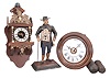 Clocks- 3 (Three): (1) Dutch reproduction wall clock, 8 day, time and strike, weight driven movement in a mahogany case with cast brass ornaments, silvered chapter ring, and topped by a figure supporting a sphere of the heavens, c1970; (2) Black Forest, Germany, two-weight wall or "postal" clock, 30 hour, time and alarm, weight driven wood-plate movement with a turned wood bezel and back-painted glass dial, c1880; (3) Peddler figure novelty clock, 30 hour, time only, spring driven movement in a painted cast metal figural case depicting a German clock peddler carrying two wag-on-the-wall clocks, c1990.