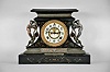 Ansonia Clock Co., New York, "Rosalind" 8 day, time and spring brass movement cast iron black mantel clock with visible escapement. A plaque on the case reads: "Presented by Mr. & Mrs. B. Uberwasser", Sept. 15th, 1906 ".