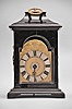 Austria, small bracket clock, 30 hour, time and alarm, round spring driven movement with verge escapement in an ebonized wood case with ogee molded base and pagoda top with gilt carrying handle, case sides with figural gilt mounts, gilt shield-shaped dial with engraving, matted center, and Roman numeral applied silvered chapter ring, silvered alarm set ring, and a single blued steel hand.