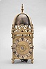 Peter Closon, London, a mid 17th century striking lantern clock, the brass case with turned, tapered columns at the corners, with ball feet and ornate urn finials, the top with arcaded brass gallery fixed to the top plate, and with a second top above, screwed to the lower plate and located by pins formed from extensions of the columns, three sides with engraved, foliate frets, and top with brass bell strap with finial and large bell, dial plate with foliate engraved corners, the center with engraved tulips, and signed "Peter Closon Neere Holburn Bridge Londini Fecit", silvered brass chapter ring with roman numerals and matchstick flower half hour markers and single, cut steel hand, movement with crown wheel escapement and count wheel striking, crown wheel made of steel instead of the more ususal brass, contrate wheel with three spoke crossing dovetailed to the rim, hour wheel and ratch with matchstick man marks