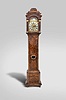 And. Vermeulen, Amsterdam, Netherlands, tall clock, 8 day, time and strike, weight driven movement in a burl walnut veneer case with stepped top, hood has frieze with blind fret and faux columns flanking door, trunk door with lenticle glass over faceted base resting on bun feet. The brass dial has silvered chapter ring, moon phase, calendar aperture and maker's signature under 6.