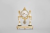 Courvoisier, a Paris, a late 18th century marble and gilt bronze mantel clock, the oblong base on toupie feet with inset, reeded mounts and central foliate ornament, and finished with a gilt bead molding, the gilt clock case with laurel and bowknot drop, and surmounted by a pyramid of fruit, the case supported bu two slender vasiform columns, with foliate and basket weave mounts, and gadrooned rings, arabic numeral white enamel dial, signed "Courvoisier a Paris", well executed pierced and engraved gilt hands, 8 day two train movement with crown wheel escapement, the Swiss style strike work mounted to the back plate, and with silk thread suspension, repeating the last hour on demand
