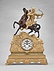 France, a gilt and patinated bronze figural mantel clock, the case replete with symmetrically arranged acanthus and other naturalistic top, the top with a rocky landscape and a Turkish archer wearing armor, astride a reddish brown patinated horse, the horse with head and one leg raised, the figure looking backward, his bowstring taut, and ready to release an arrow, Roman numeral white enamel dial with open escapement, 8 day, two train pendule de Paris movement