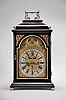 Peter Humps, in Wienn, a mid 18th century, grand sonnerie striking bracket clock with date and phases of the moon, ebonized case with molded base on turned, gilt feet, the arched, gilt lined, glazed door with textile backed engraved frets at upper corners, case sides also with glazed, gilt lined, arched windows and sound frets, the caddy top with ornate carrying handle, and flanked by four turned finials, brass composite dial with roman numeral chapter ring and arabic five minute markers, center with foliate engraving and date aperture above 6:00, and cutout to view mock pendulum below 12:00, corners with cast spandrels, and the arch with regulator, strike/ silent control, and moon phase display, blued steel hands, 30- 60 hour, three train movement with engraved backplate, decorated crutch, turned pillars with central knop, crown wheel escapement, fusee for time train, Viennese striking, and repeating the last hour and quarter on demand, and small, engraved brass pendulum bob with steel rod