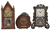 Clocks- 5 (Five): (1) Brewster Manufacturing Co., Bristol, Conn., mantel clock, 8 day, time and strike, spring driven movement in a black wood case with mother of pearl and painted decorations, c1852; (2) Brewster & Ingrahams, Bristol, Conn., sharp gothic or steeple clock, 8 day, time and strike, spring driven movement in a walnut veneer case, c1850; (3) England, mantel clock, 8 day, time only, spring driven movement with balance wheel, in wood case that was once a section of water pipe in 17th century London, c1908. (4) Ansonia Brass & Copper Co., Ansonia, Conn., "Gilt Column", 8 day, time and strike, spring driven movement in a walnut veneer case, c1874; (5) Elisha Manross, Bristol, Conn., miniature ogee shelf clock, 30 hour, time and strike, spring driven movement in a walnut veneer case and William B. Fenn eagle glass, c1850.