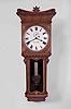Seth Thomas Clock Co., Thomaston, Conn., "Regulator No. 7" wall hanging clock, spring driven 8 day timepiece movement with maintaining power in a walnut case.