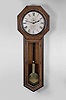 Seth Thomas Clock Co., Thomaston, Conn., "Regulator No. 18" wall hanging clock with a weight driven 8 day timepiece movement with maintaining power in an oak case.