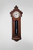 E. Howard & Co., Boston, Mass., "No. 36 Regulator", 8 day, time only, weight driven movement with Graham deadbeat escapement, meter long pendulum with loaded glass jar in a carved walnut case with mirrored back and painted metal dial.