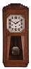 Clock- 2 (Two) German wall: (1) Fabrication Girod, Morbier, France, box clock, 8 day, time and strike with Westminster chime, spring driven movement in an oak case with silvered dial and octagonal pendulum, c1930; (2) Gebruder Junghans AG, Schramberg, Germany, box clock, 8 day, time and strike with Westminster chime, spring drive movement in an oak case with silvered dial, c1925.