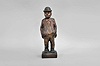 Karl Griesbaum, Triberg, Germany, whistling gentleman, spring driven brass movement powering bellows, slide whistle, and turning head motion, enclosed in hand carved wooden figure depicting a man wearing an bowler hat and bow tie with his hands in his pockets as he whistles a tune.