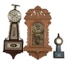 Clocks- 2 (Three) wall: (1) E. Ingraham, Bristol, Conn., "Crown Drop" hanging clock, 8 day, time and strike with alarm, spring driven movement in an oak case with thermometer and spirit level, c1895; (2) Waterbury Clock Co., "Alameda" miniature banjo clock, 30 hour, time only, spring driven balance wheel movement in a wood case with glass tablets, c1913; (3) New England Clock Co., Farmington, Conn., banjo clock, 8 day, time and strike, spring driven movement in a hardwood case, c1975.