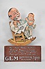 The Gem Cutlery Company, New York, "GEM Damaskeene Razor" animated advertising display, articulated pressboard figure of a father shaving with a baby on his knee, spring driven pendulum movement with simple escapement on a wood base.