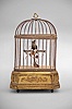 France, singing bird automaton, spring driven movement powers birdsong, as well as head, beak and tail feather motions, mounted on a gilt wood base with fluted canted corners and applied floral ornaments, the bird enclosed in a wire cage with velvet lined base and simulated flowers.