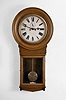 Waterbury Clock Co., Waterbury, Conn. "Regulator No. 20" wall clock with a double weight driven timepiece movement in an oak case.