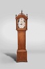 New England tall clock, 8 day, time and strike, weight driven movement in a cherry case with fretwork top, three brass finials and fluted columns on hood over trunk with fluted corner columns with brass capitals over base resting on ogee feet