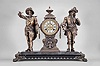 Ansonia Clock Co., New York, "Don Caesar and Don Juan" figural mantel clock, 8 day, time and strike, spring driven movement with visible Brocot escapement, black enameled iron base on paw feet supporting clock with cream enamel dial and Louis XV style hands, flanked by the two soldier figures.