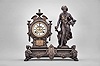 Ansonia Clock Co., New York, "Summer" figural mantel clock, 8 day, time and strike, spring driven movement with visible Brocot escapement within an ornate cast metal case, the base with paw feet and swags supporting a female figure carrying a bundle of flowers, the clock with urn top, white enamel dial, and gold Louis XV style hands.
