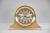 Chelsea Clock Co., Boston, Mass., "Ship's Strike" wall clock, retailed by Negus, New York for the ship "PENGUIN", 8 day, time and ship's bell strike, spring driven movement in a round brass case with 8 inch silvered metal dial accompanied by bench made wooden stand, serial #605321