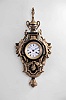 Raingo Freres, Paris, cartel clock, the gilt bronze case with classical ornament, the top with urn finial above flanking bow knots at the sides, issuing a pair of laurel garlands, the festoons pinned together at the center below the dial and terminating before the guilloche molded pendulum aperture, the laurel partially obscured by a pair of upturned acanthus leaves, and the base with bound acanthus leaf and pendant husk drop, the gilt, beaded bezel with beveled glass, Roman numeral white enamel dial, blued steel Breguet style hands, 8 day time and strike pendule de Paris movement sounding the hour and half hour on a bell, dial and movement signed