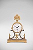Lenzkirch AG, Lenzkirch, Germany, desk clock, 8 day, time only, spring driven movement with lever escapement in a cylindrical brass drum supported by an ornate cast brass case and topped with floral finial, white enamel dial with blued steel spade hands.