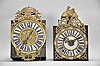 Clocks- 2 (Two) Comtoise with Cartouche Numerals: (1) France, bronze-front Comtoise clock, 8 day, time and strike with alarm, weight driven movement with verge escapement, thread suspension with rear-hanging pendulum in an iron post and plate frame, cast brass dial with royal symbols including a crown and profile of Louis XV, white enamel cartouche numerals with blue lettering, topped by cast fronton featuring fleur de lis and the backward facing Gallic rooster, applied lower casting, and single iron hand, mid 18th Century. (2) France, bronze-front Comtoise clock, 8 day, time and strike with alarm, weight driven movement with verge escapement, thread suspension with rear-hanging pendulum in a posted frame, 25 white enamel panels inset within cast brass dial, two iron hands, pieced brass spandrels, and topped by cast fronton with backward facing Gallic rooster, mid 18th Century.