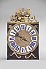 France, Comtoise clock, 8 day, time and strike with alarm, weight driven movement with rare Maillet (or Mayet) escapement and unusual double vertical rack strike in a posted iron frame, cast brass dial with profile of young Louis XV with inset white enamel cartouches with blue Roman numerals, alarm ring with Arabic numerals, single pierced iron hand, brass spandrels above and pivoted winding arbor shutters below, all topped with a pierced brass fronton with floral motif.