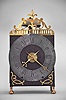 France, oversized Comtoise lantern clock, month running, time and strike with alarm, weight driven movement with verge escapement, rear-mounted thread suspension in a iron post and plate frame with turned brass feet in the front, pewter chapter ring with Roman numerals for the hours, outer ring with Arabic numerals every 5 minutes, brass alarm ring with Arabic numerals, pierced flat brass fronton and lower spandrels, and two brass hands.
