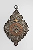 Southern Germany or Austria, telleruhr clock, 8 day, time and strike, spring driven movement with verge escapement and cowtail pendulum, mounted to an iron plate covered in copper relief birds, palmettes, and human faces on a scrolling field, the pendulum arbor cover in the form of a double-headed eagle, copper chapter ring with Roman numerals for the hours and Arabic numerals at five minute intervals, pierced brass hands with copper finish.