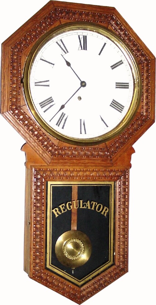 C.1911, Ingraham Clock Co., "Hartford" 8-day pressed oak long drop school regulator. — Antique Clocks Price Guide