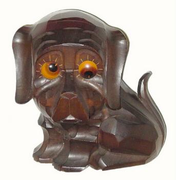 C.1935, German, "Oswald" Carved dog rolling eye novelty. 30-hour backwind timepiece movement with rolling eyes indicating the time. — Antique Clocks Price Guide