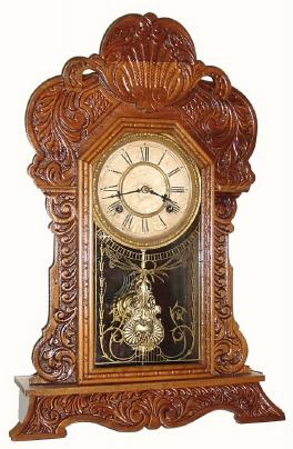 C.1906, Waterbury Clock Co., "Davis", Walnut Gingerbread clock in very good restored condition. — Antique Clocks Price Guide
