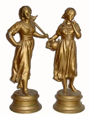 C.1904, Ansonia PEASANT GIRLS, a garniture set in good, as-found condition, old gold paint applied maybe 50 years ago and flaking. — Antique Clocks Price Guide