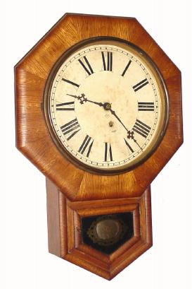 C.1900, Ansonia Clock Co., 8-day oak veneer schoolhouse timepiece in very good condition. — Antique Clocks Price Guide
