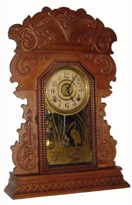 C.1900, E. N. Welch Mfg. Co., 8-day time/strike/alarm oak case gingerbread shelf clock in clean condition with original dial, hands, pendulum and tablet. — Antique Clocks Price Guide
