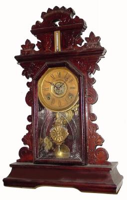 C.1885, E. Ingraham &amp; Co., 8-day time/strike/alarm gingerbread clock in pretty good condition with a heavy coat of the varnish over the original finish. — Antique Clocks Price Guide