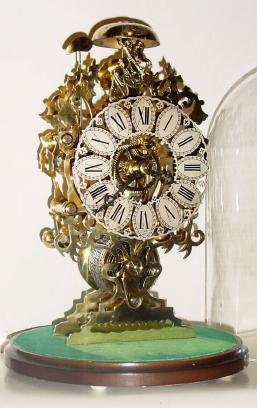 Mid 20th Century, English, Passing Strike Skeleton clock in a delicate scroll &amp; leaf style frame with engraving on the front plate. — Antique Clocks Price Guide