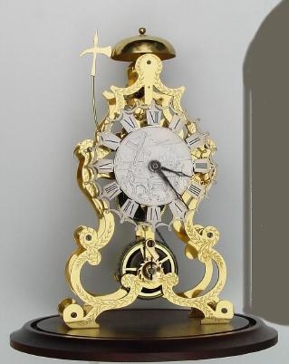 Mid 20th Century, English, Passing Strike Skeleton clock in a large scroll frame with profuse engraving on the front plate. — Antique Clocks Price Guide