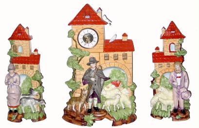 C.1950, German, 3-piece Porcelain Mantel set in generally good condition, with repairs to the tips of both side vases, and a center crack under the Shepherd, visible when you turn the piece over. — Antique Clocks Price Guide