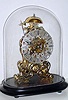 Mid 20th Century, English, Passing Strike Skeleton clock in a scroll frame patterned after the famous Arabesque by Evans, considered the most beautiful skeleton clock model.