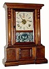 C.1868, Seem Patent Dial, on a C.1870 rosewood shelf case with a C.1900 Waterbury gingerbread movement (the rear mounting lugs were simply cut off with nippers so the movement could be block mounted) 