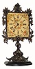C.1900, German, night clock timepiece, 30-hour, in very nice condition with an original bronze finished iron frame & stand.
