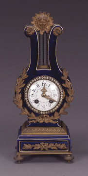 A LOUIS XVI STYLE ORMOLU-MOUNTED AND 'JEWELED' BLUE-GROUND PORCELAIN LYRE CLOCK, Late 19th/early 20th century, retailed by Blair &amp; Crawford. — Antique Clocks Price Guide